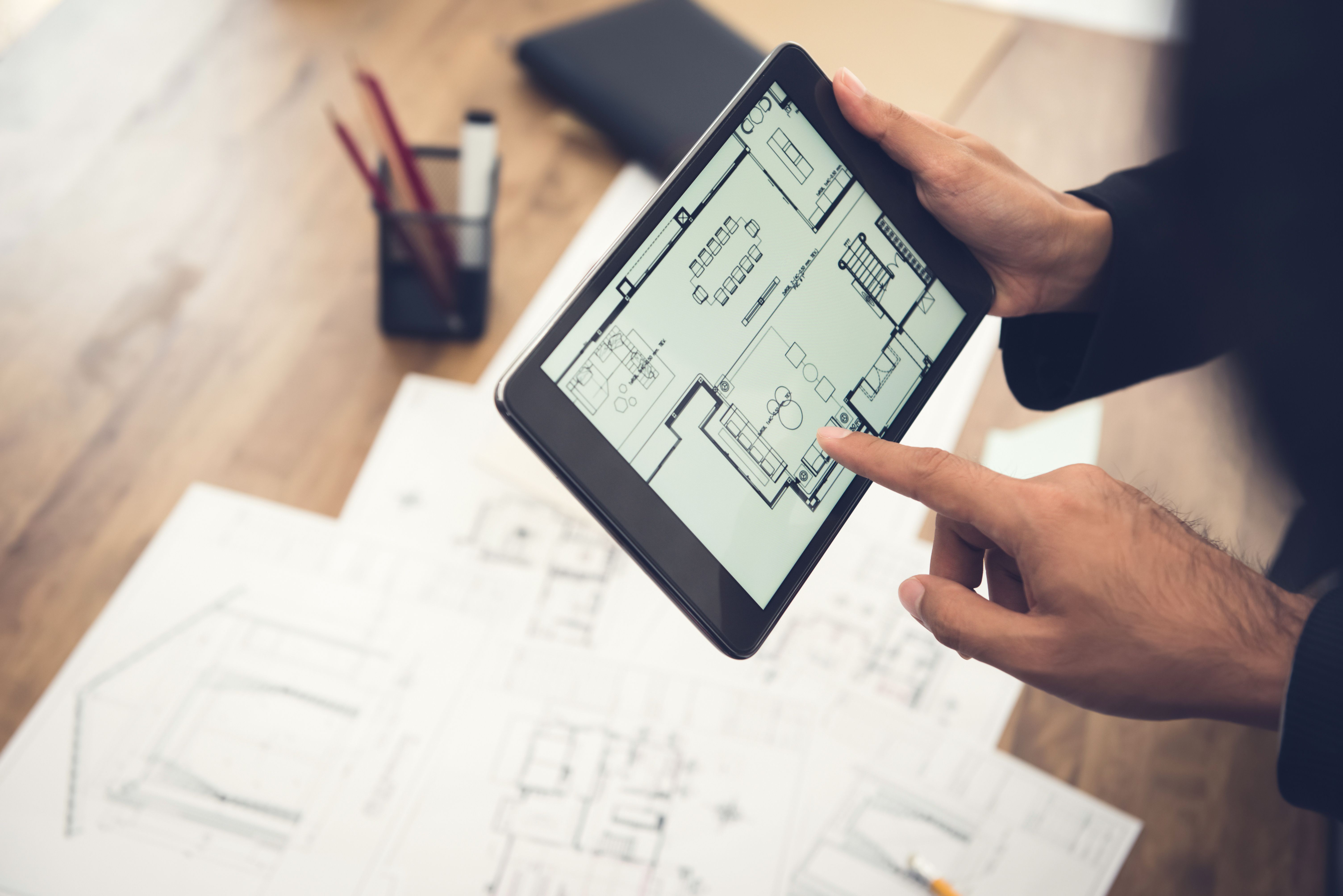 real-estate-agent-architect-presenting-house-floor-plan-client-tablet-computer